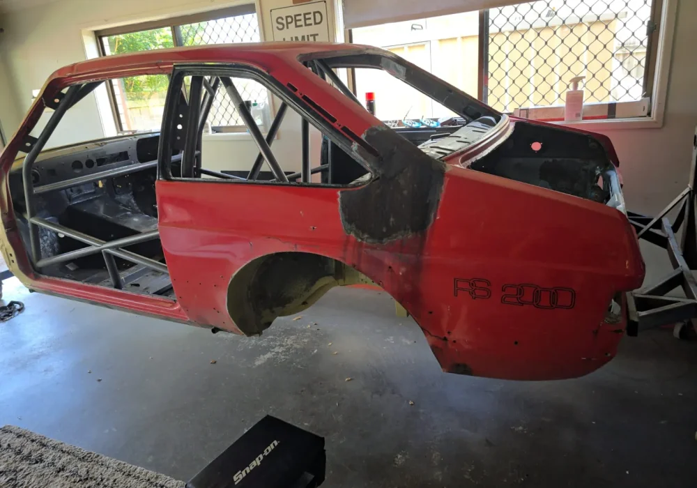 Car restoration project showing bodywork and repair process